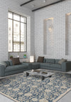 Modern living room with gray sectional sofa, coffee table, and decorative rug on white brick walls.