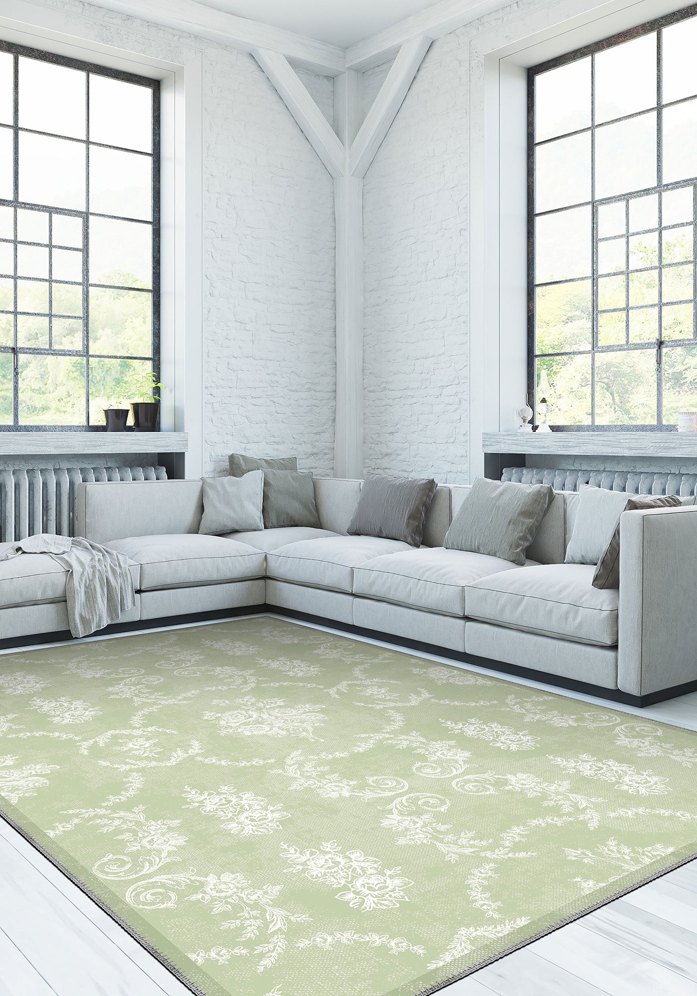 Modern living room with a light gray sectional sofa and a green patterned rug.