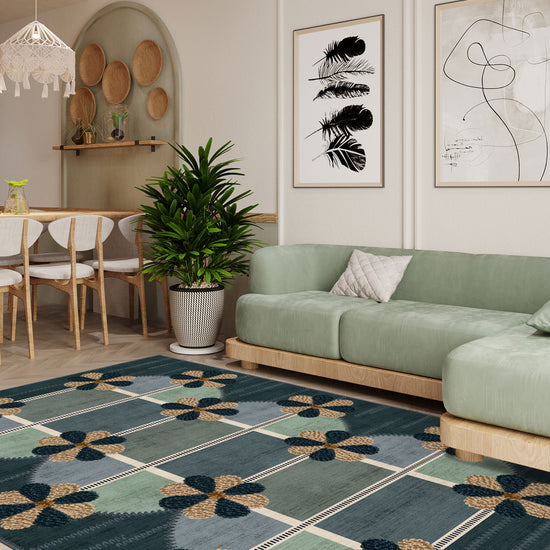 Living room with a green sofa, patterned rug, and decorative wall art.