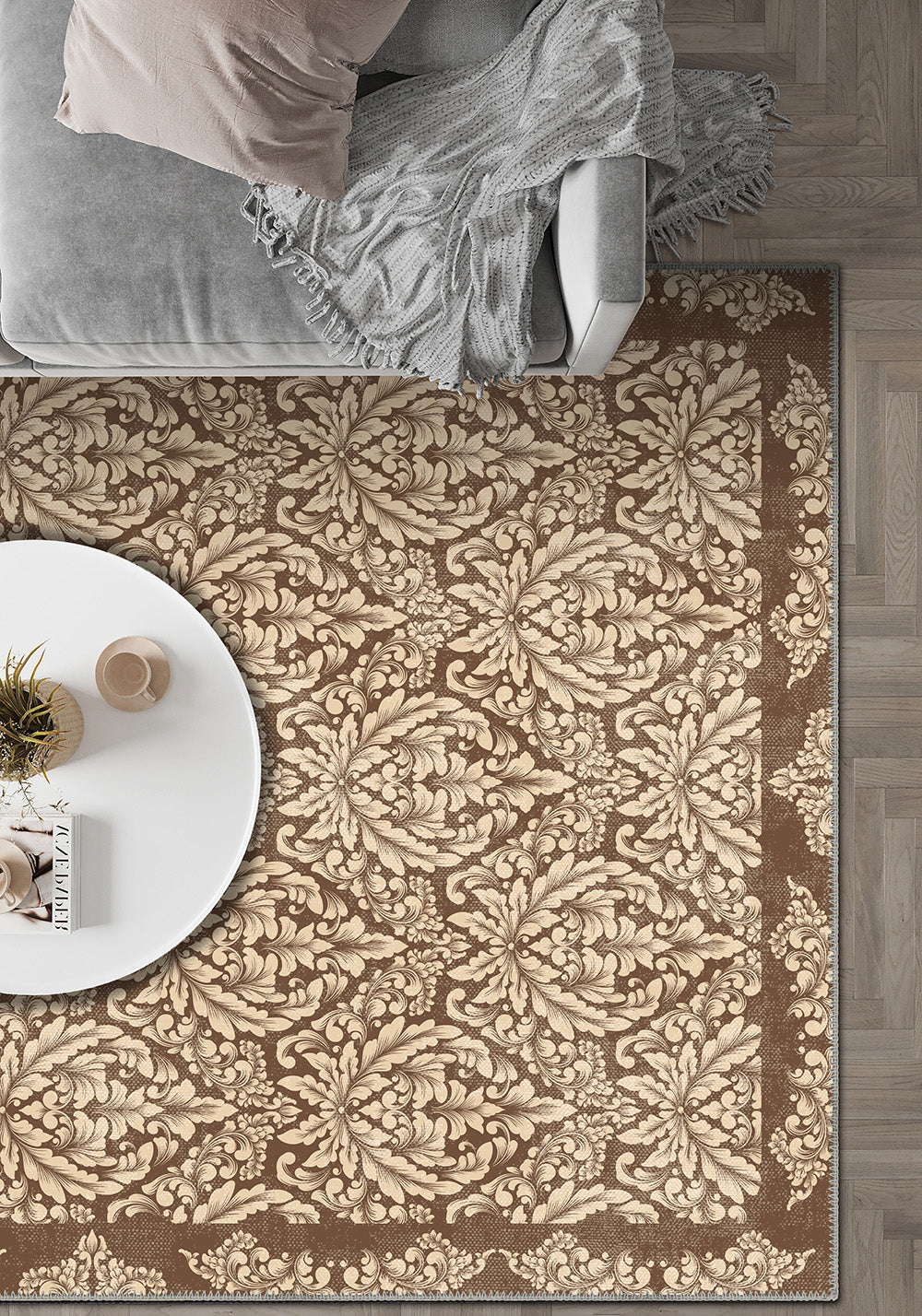 Patterned beige and brown rug in a room with a sofa and small table.