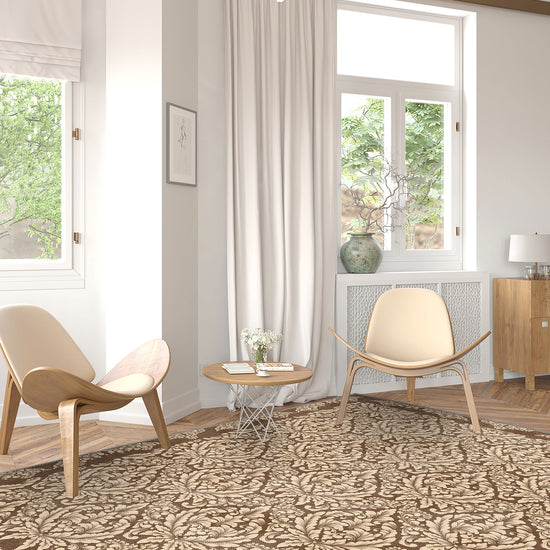 Modern living room with patterned rug, chairs, and large windows.